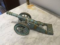 Front perspective showing entire miniature cannon on marble surface