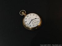 Angled view of watch face and case, showing overall condition and gold-filled finish