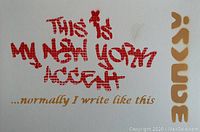 Full view of white watercolor paper with red stenciled graffiti text and gold accents