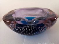 Side-front view showing overall shape, bubble inclusions and purple-to-blue gradient.