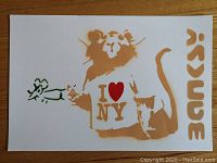 Full view of stencil‐style rat wearing an “I ♥ NY” shirt and holding a green outline rat on white paper