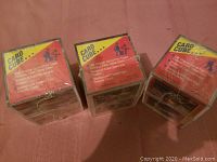 Photo of three sealed 1991 Topps Card Cubes, each containing 150 original out-of-print baseball cards, unopened in plastic wrap.