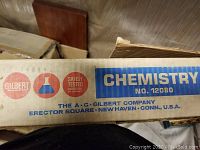 Top view of original A.C. Gilbert Company Chemistry Set No. 12080 box label with brand and safety-tested logo.