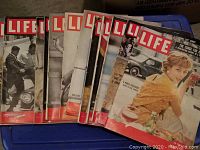 Stack of vintage Life magazines with visible covers showing mid-20th century photography and mastheads