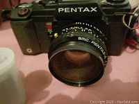 Front view of the Pentax camera with SMC Pentax lens attached showing camera model in white lettering