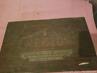 Closed wooden box with faded Erector label on lid.