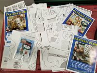 Collection of paper woodworking templates including booklets and loose pages with woodcraft pattern designs and instructions.