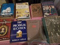 Photo of 10 vintage books including 'The Orange Woman' by James Williams, 'The Prodigal Women' by Nancy Hale, 'Mississippi River' by F.A. Botkin, and 'Kenneth Roberts The Lively Lady - Captain Caution'. Shows book covers, some with wear and discoloration.
