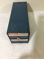 Closed blue metal organizer labeled Sprague Ceramic Capacitors with two drawers.