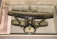 Mini airplane silver-tone clock displayed inside original box with clear top window and Sheffield branding.