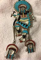 Full front view of the Kachina pendant showing the colored inlay and dangling ornamental faces