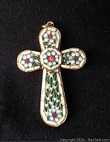 Front view of vintage micro mosaic cross pendant showing intricate floral pattern and goldtone setting.