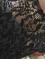 Close-up showing the floral lace pattern and mesh background