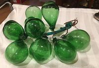 Cluster of large green glass grapes showing overall size and color on a white towel backdrop