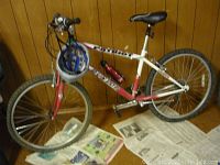 Full side view of Dunlop Patriot mountain bicycle with blue helmet hanging on handlebar, displaying overall frame and tires.
