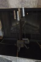 Full view of fireplace tool set positioned in front of fireplace, showing all four tools and the stand.