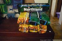 Stack of 7 fire logs with Northland fire log packaging visible on top