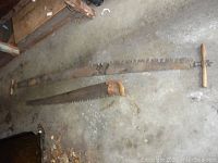 Overview of both saws laid on garage floor