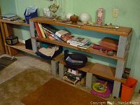 Wide view showing shelving units with various household items such as books, decorative bowls, and kitchenware arranged on shelves.