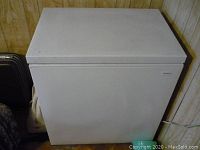 Front view of small white Coldspot chest freezer showing overall condition and top lid closed.