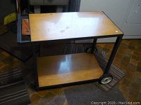 Full side view of the rolling work cart showing top and bottom wooden shelves, metal frame, and wheels.