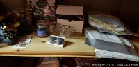Shelving with candles, glass candle holders, boxed items, ziplock bags with other decorations