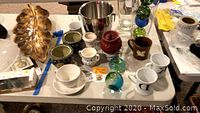 Wide view of all items including mugs, ice bucket, decorative spheres, brass leaf dish