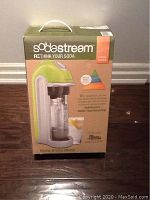 Front view of the boxed SodaStream limited edition home drinks maker with green and white design visible, showing product branding and image.