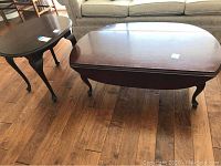 View of cherry wood coffee table and accent table showing overall size and condition including scratches and legs style.