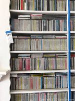 Photo showing 7 shelves filled with classical music CDs, tightly packed with visible white shelving