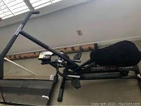 Full overview of the Health Rider fitness machine with black frame and pedals, positioned indoors near wall and window.