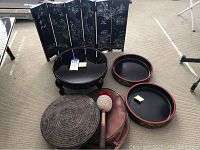 Full set of lot items including the folding screen, gong on stand, trays, base, and mallet arranged on carpeted floor.