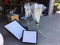 Two light kits on tripods with softbox diffusers laid out
