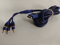 Blue Monster AV cable coiled, showing RCA connectors for composite video/audio.
