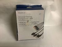 Full view of the Insignia branded box containing the universal gaming component cable, showing front and side with product details.