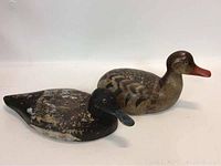 Two wooden duck decoys side by side showing overall condition and detail.