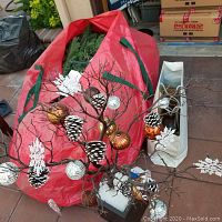 36-inch ornament tree decorated with white pine cone, snowflake, copper and bronze colored ball ornaments, miniature disco balls, and icicle shaped clear ornaments on bare brown branches in a black square base with white filler.