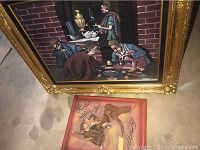 Two pieces of Middle Eastern art; large framed painting above smaller relief wall art with calligraphy