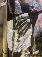 Six replica firearms displayed on table: five pistols and one long rifle.