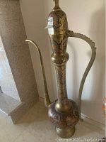 Full view of the tall hand-painted metal kettle showing body, spout, and handle.