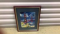 Full view of framed painting of Golden Gate Bridge in San Francisco with flowers.