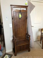 Full view of antique oak hall tree with storage bench, coat hooks, and mirror