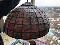Side view of dome-shaped stained glass light fixture showing textured multi-colored glass panels