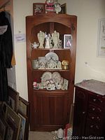Full view of the pine corner cabinet from an angle, showing height and corner placement.