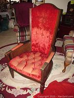 High back wood accent chair with red velour upholstery, tufted seat, cane sides, and dark wood frame showing scratches and wear.