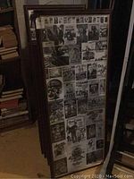 Framed collage featuring various movie-themed clippings with dark wood frame, leaning against wall.