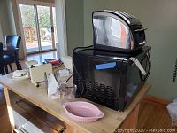 Photo of microwave with T-Fal 4 slice toaster on top, small kitchen items and dishes in background