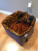 Front and side view showing plush tiger stripe interior and black safety straps.