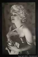 Framed black-and-white print of Marilyn Monroe holding a Chanel No.5 bottle, full view