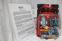Overall shot showing the signed Certificate of Authenticity and original sealed package of Mr. Freeze deluxe action figure with vehicles.